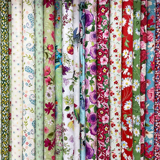 rolls of beautifully printed quilting fabrics