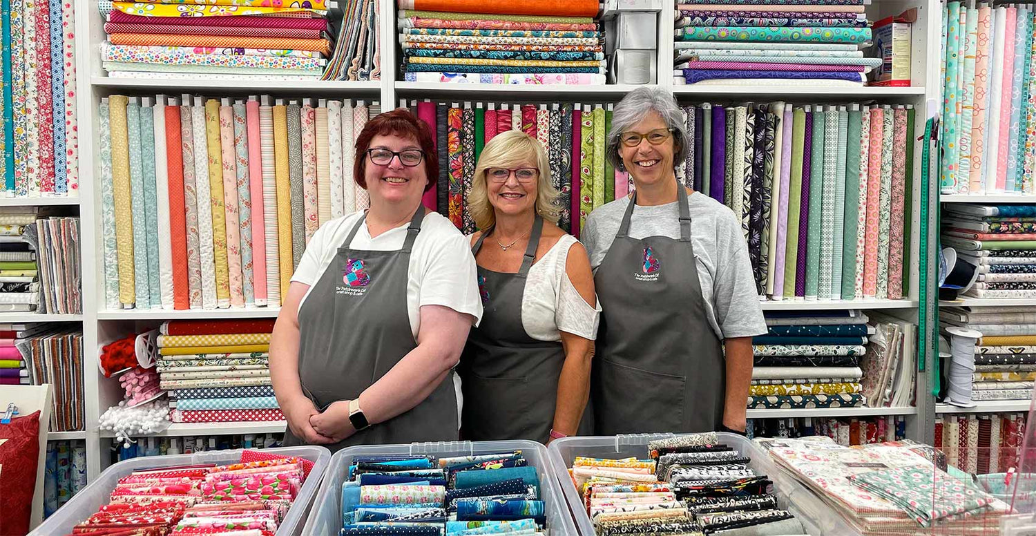 The Patchwork Cat team in the fabric shop area