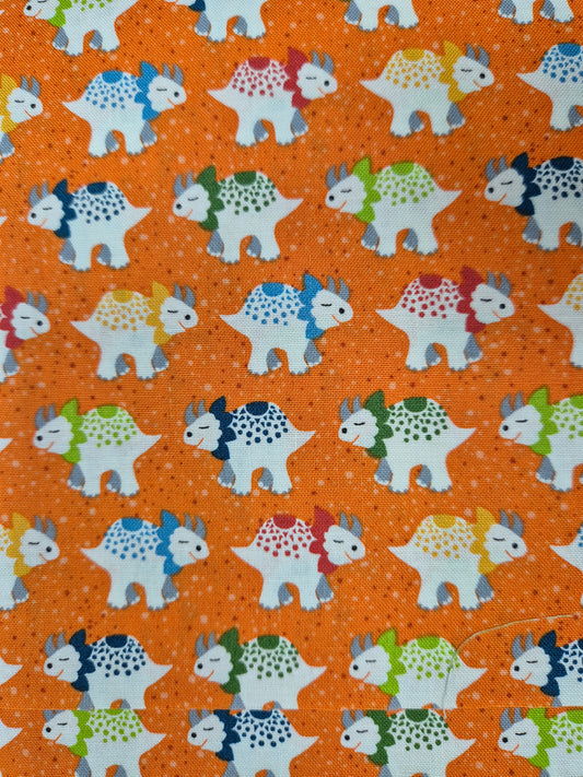 orange triceratops pattern fabric