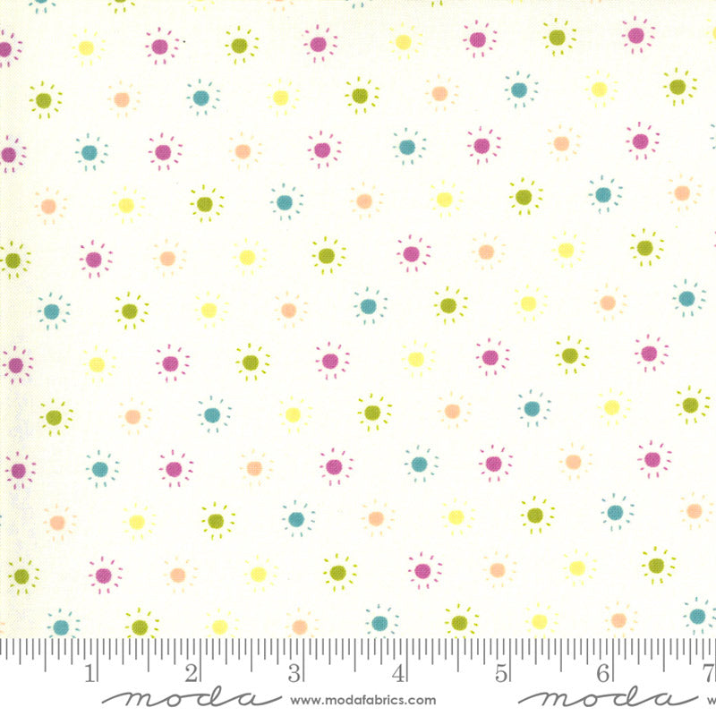 Moda fabric with colourful starbursts in green, blue, magenta, yellow and orange.